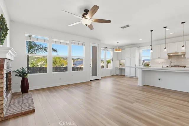 a kitchen with white cabinets and appliances