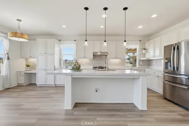 a kitchen with cabinets and window