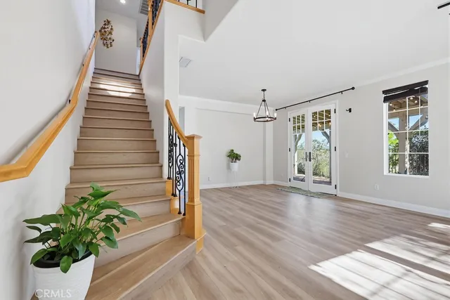 a view of a livingroom with a fireplace a ceiling fan and wooden floor