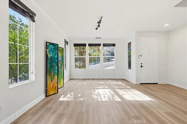a view of an entryway with wooden floor and windows