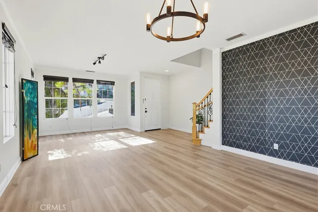 a view of a livingroom with a ceiling fan fireplace and a window