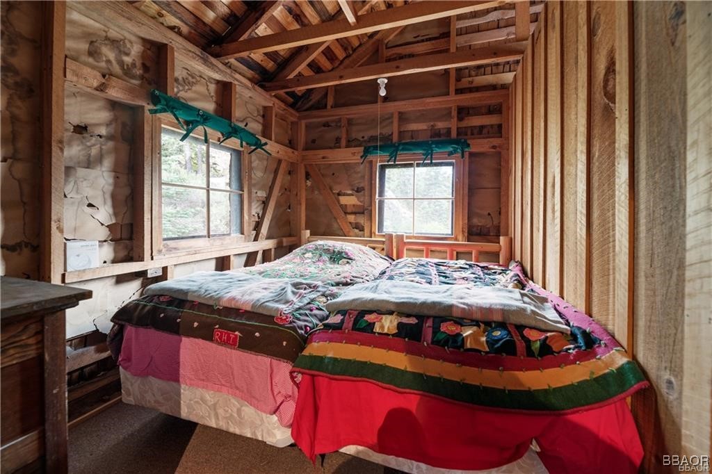 46 Spring Road Big Bear Lake, CA 92315 - Photo 16 of 43 a bed sitting in a bedroom next to a window
