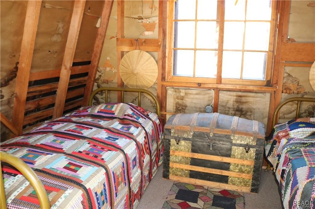46 Spring Road Big Bear Lake, CA 92315 - Photo 24 of 43 a bed sitting in a bedroom next to a window