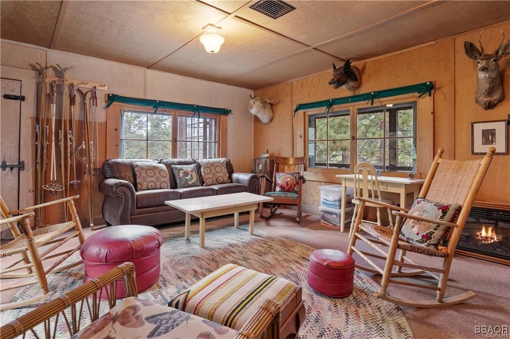 46 Spring Road Big Bear Lake, CA 92315 - Photo 5 of 43 a living room with furniture a fireplace and a large window