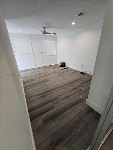 a room with stairs and wooden floor