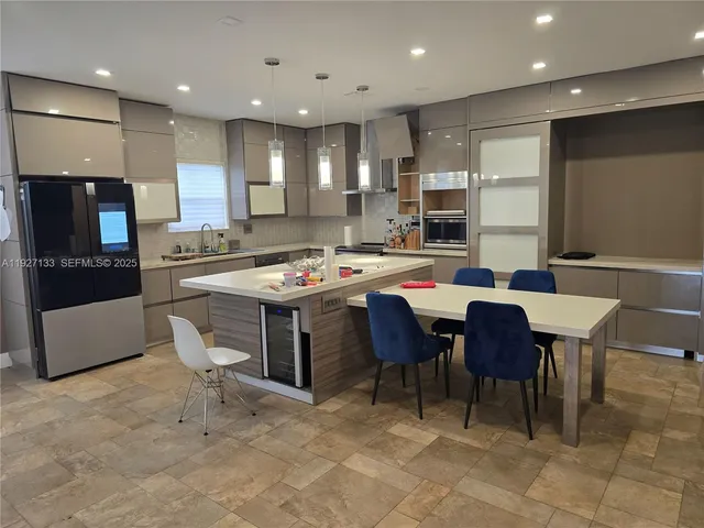 a large kitchen with a table and chairs