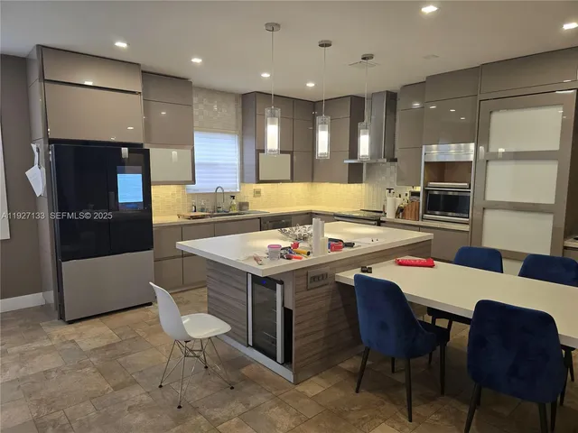 a kitchen that has a table and chairs in it