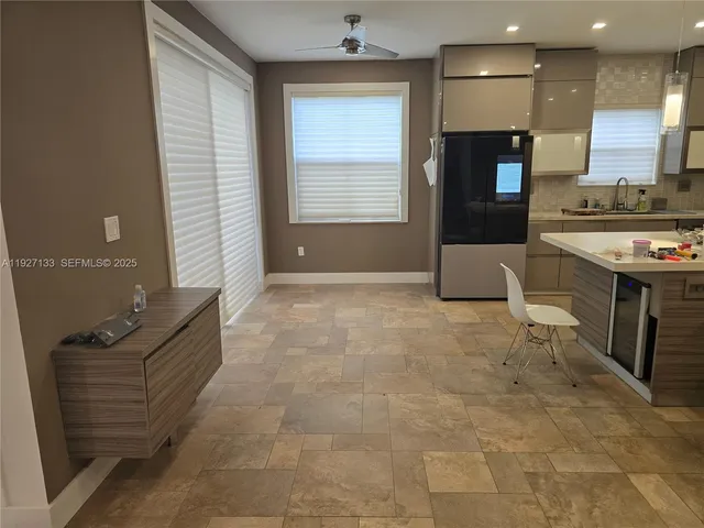 a view of kitchen with stainless steel appliances granite countertop a stove a sink and a refrigerator