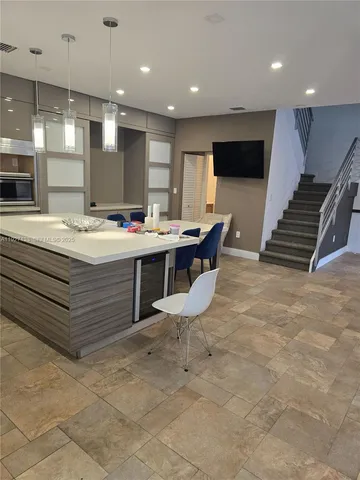 a room with a stove a table and chairs in it