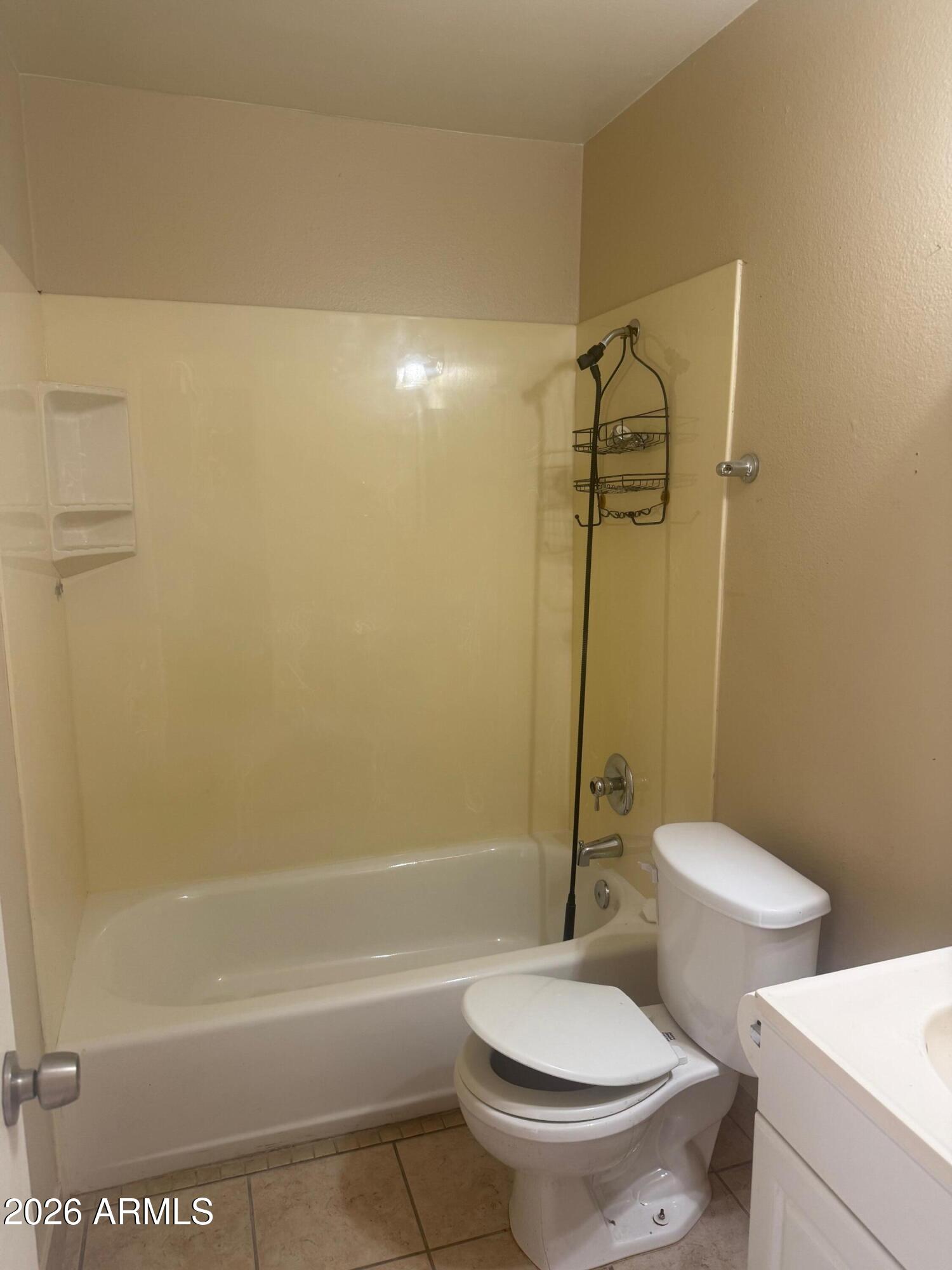 1622 East Campbell Avenue, Unit R Phoenix, AZ 85016 - Photo 11 of 15 a white toilet sitting next to a bath tub and a shower