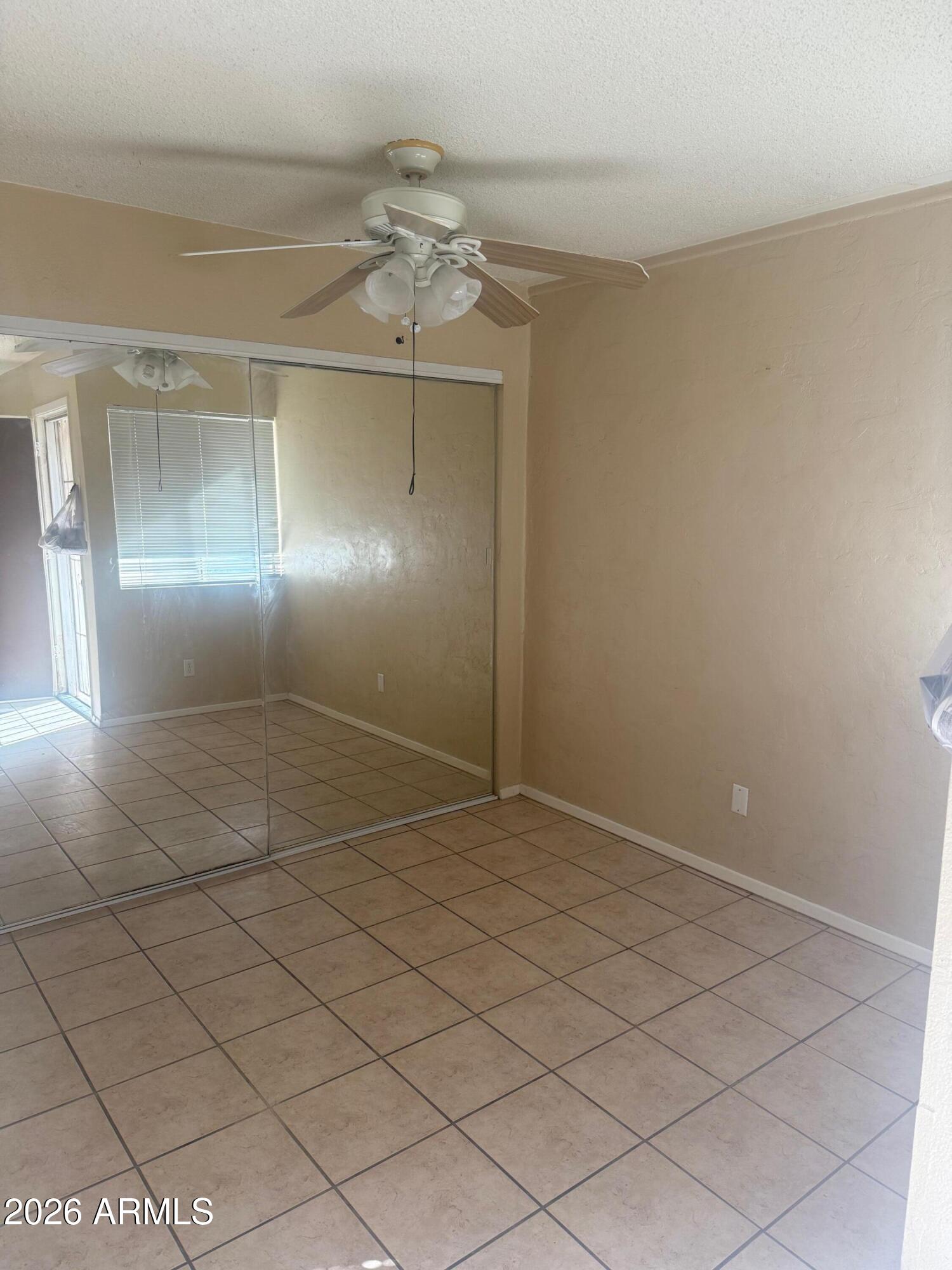 1622 East Campbell Avenue, Unit R Phoenix, AZ 85016 - Photo 6 of 15 a view of an empty room with a chandelier fan