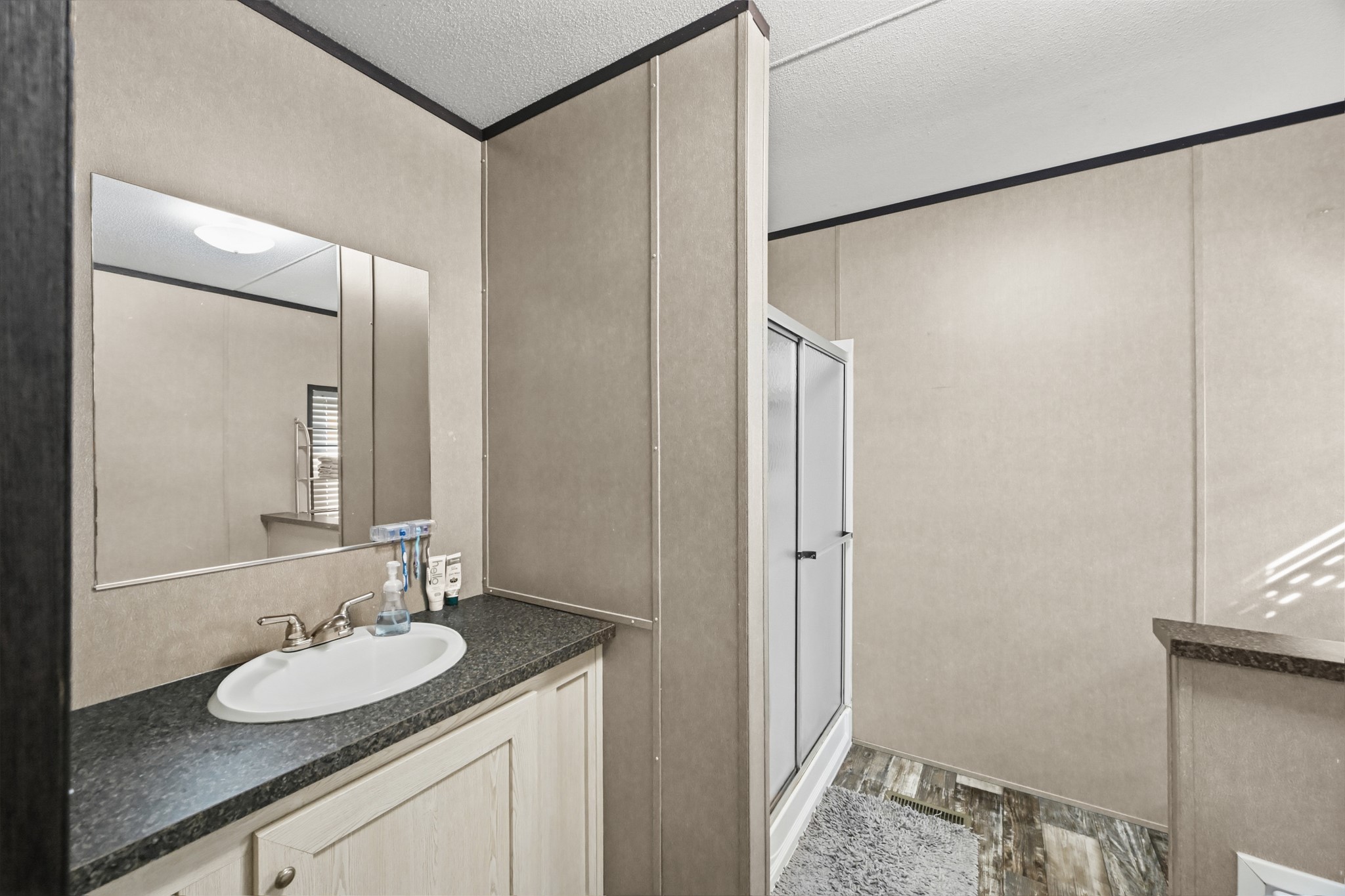 6026 Carter Road Waller, TX 77484 - Photo 19 of 34 a bathroom with a granite countertop sink and a mirror