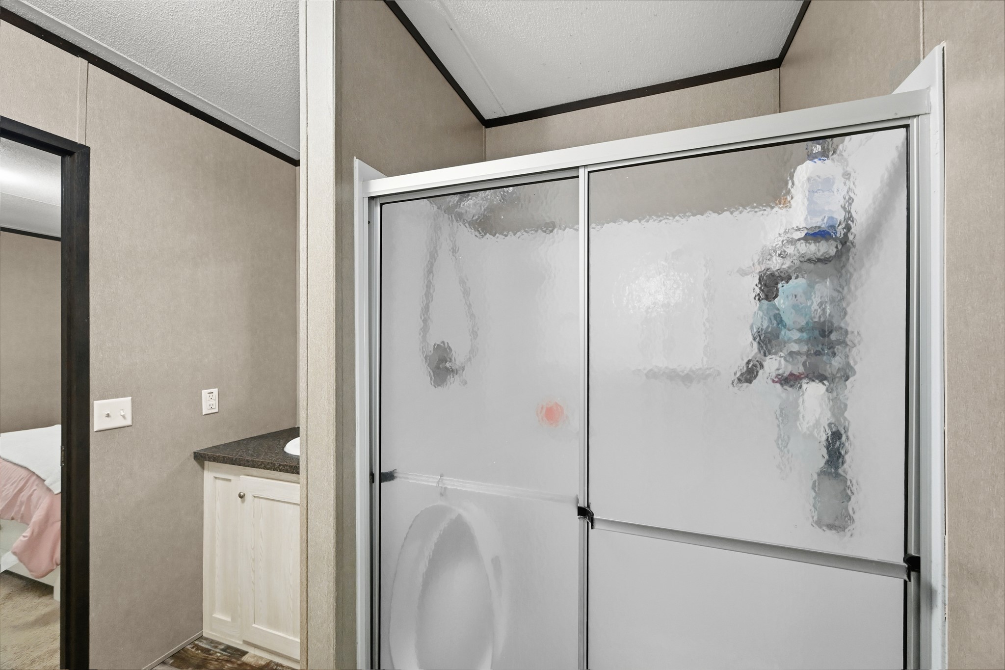 6026 Carter Road Waller, TX 77484 - Photo 21 of 34 a bathroom with a glass shower door and a shower