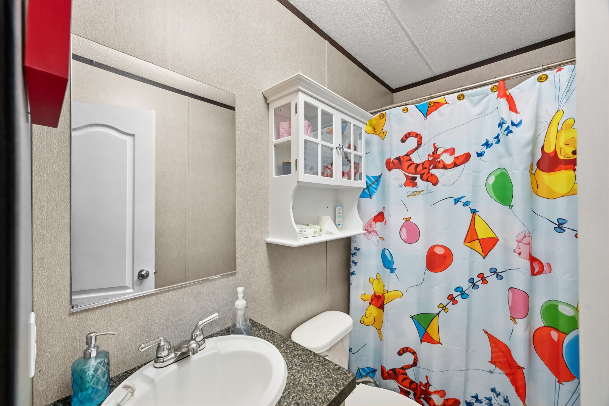 6026 Carter Road Waller, TX 77484 - Photo 24 of 34 a bathroom with a sink and a blue curtain
