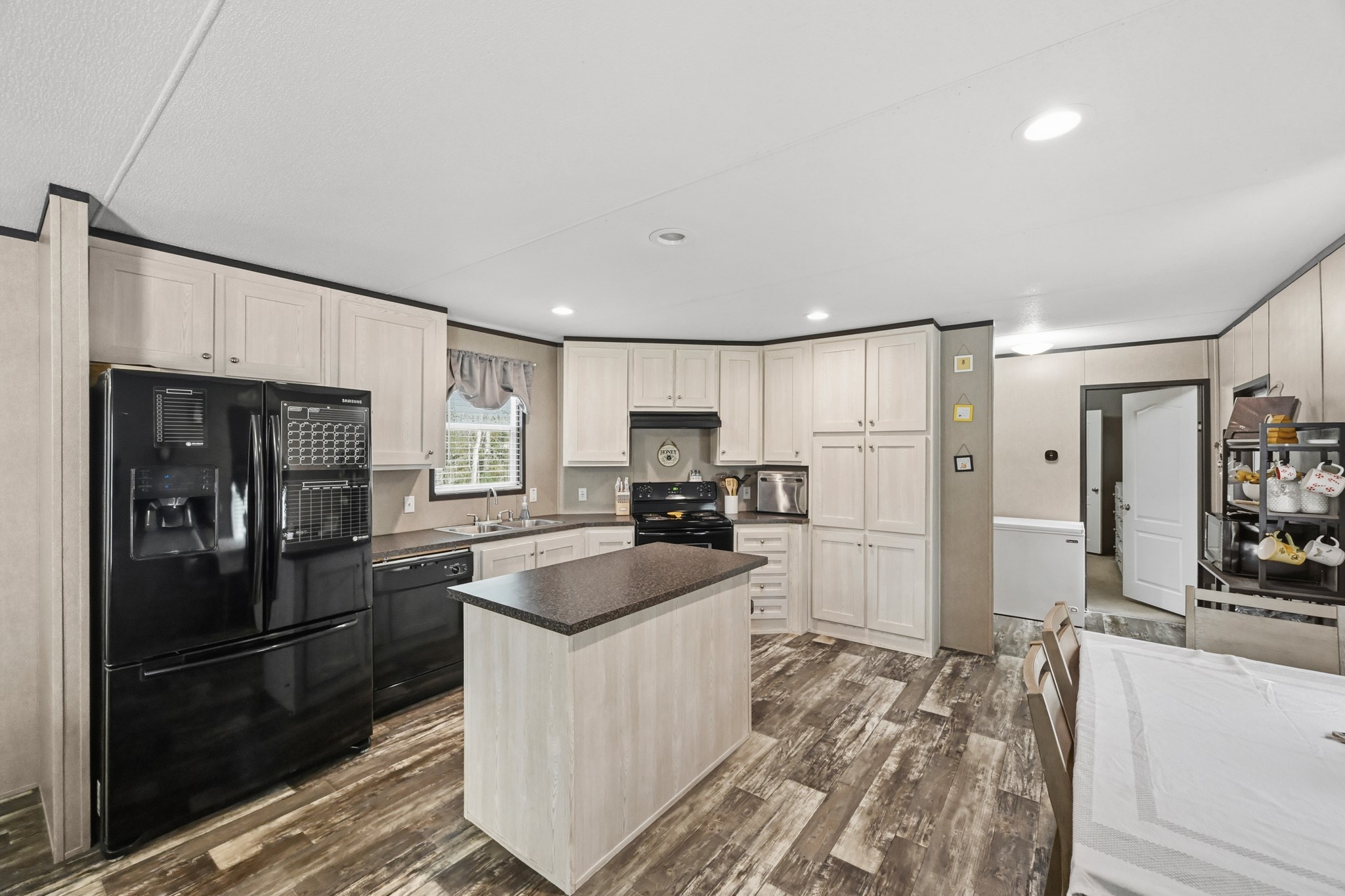 6026 Carter Road Waller, TX 77484 - Photo 9 of 34 a kitchen with granite countertop a refrigerator stove and sink