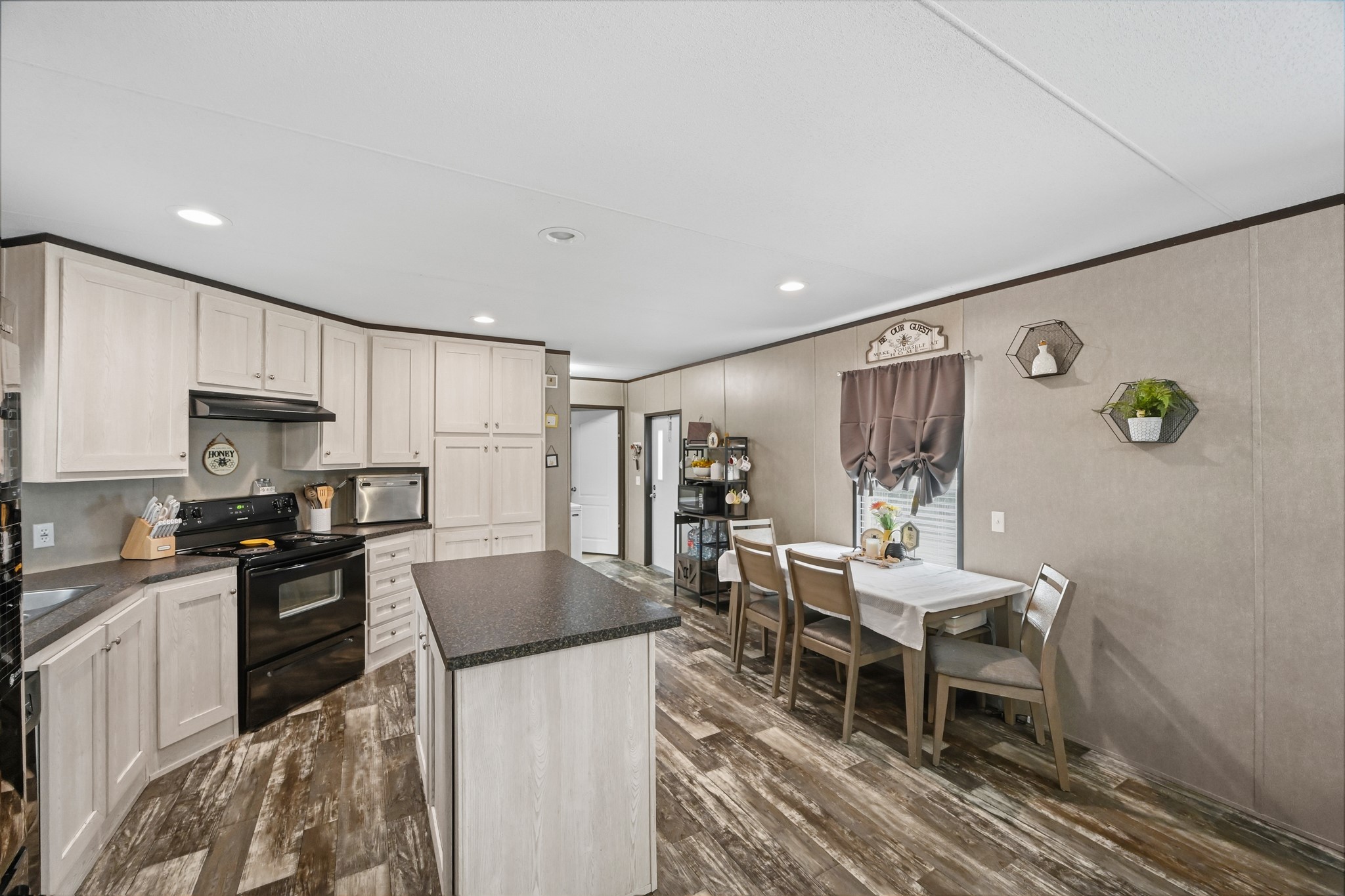 6026 Carter Road Waller, TX 77484 - Photo 10 of 34 a kitchen with stainless steel appliances kitchen island granite countertop a sink and cabinets