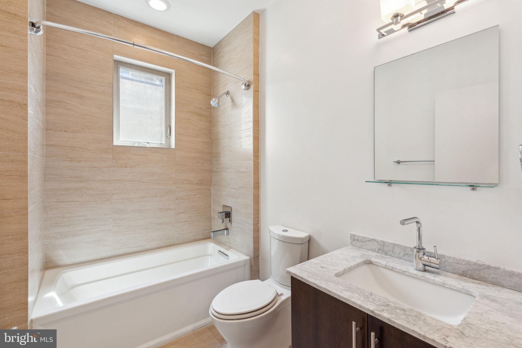832 North 3rd Street, Unit 7 Philadelphia, PA 19123 - Photo 26 of 52 a bathroom with a granite countertop sink toilet and shower