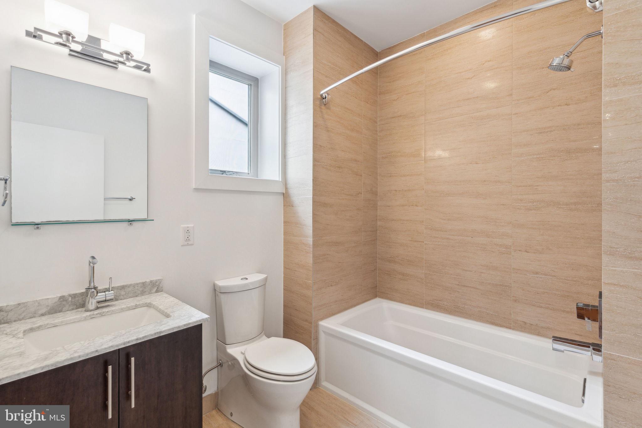 832 North 3rd Street, Unit 7 Philadelphia, PA 19123 - Photo 34 of 52 a bathroom with a granite countertop sink toilet and shower
