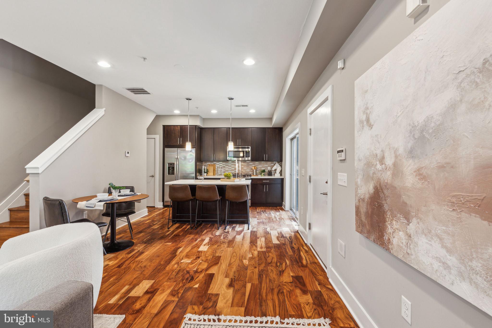 832 North 3rd Street, Unit 7 Philadelphia, PA 19123 - Photo 6 of 52 a living room with stainless steel appliances furniture a rug and a kitchen view