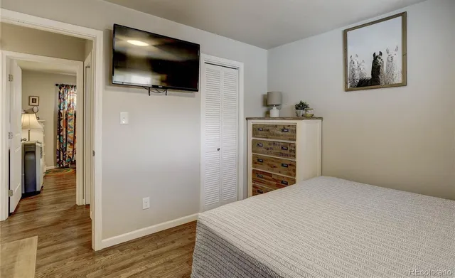 a bedroom with a bed and a flat screen tv