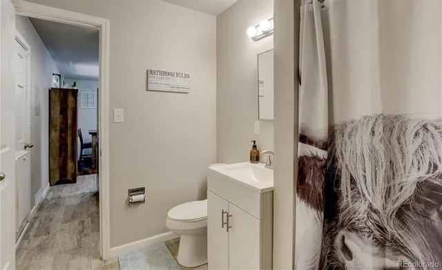 a bathroom with a toilet sink and shower