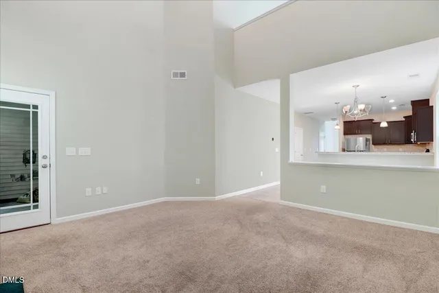 an empty room with entrance and mirror