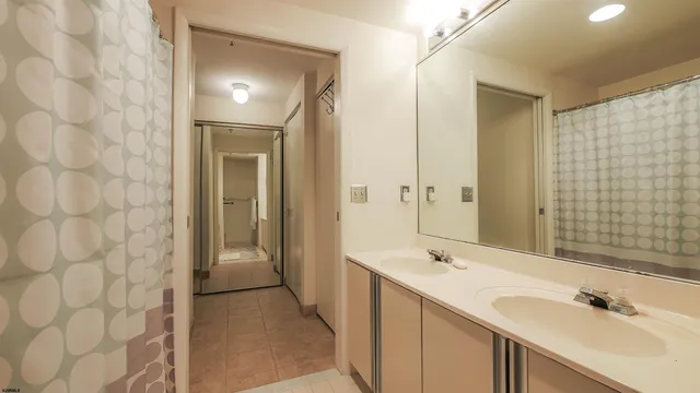 a bathroom with a sink a mirror and a shower