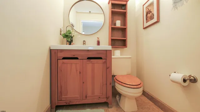 a bathroom with a toilet a sink and a mirror