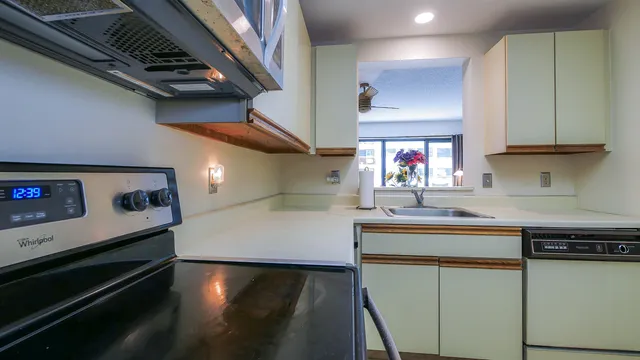 a kitchen with stainless steel appliances granite countertop a sink and a stove