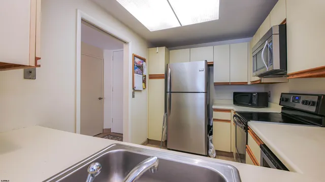 a kitchen with a refrigerator and a sink