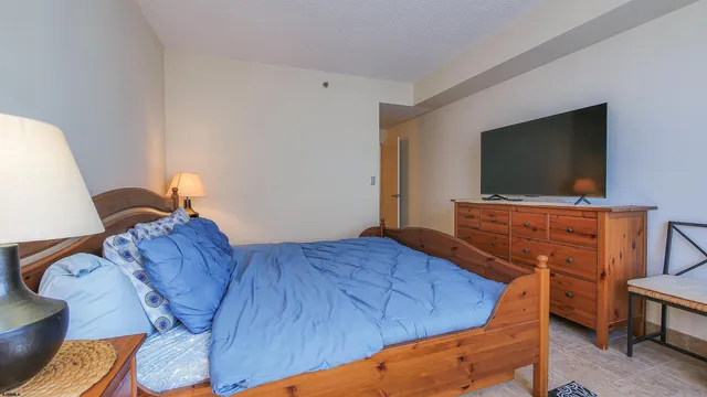 a bedroom with a bed and a flat screen tv