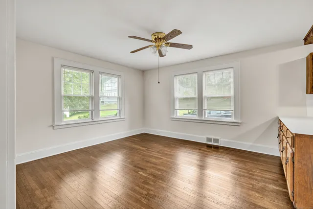 a view of a livingroom with a window and wooden floor
