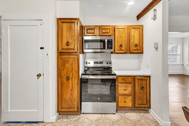 a kitchen with stainless steel appliances granite countertop a refrigerator and a stove