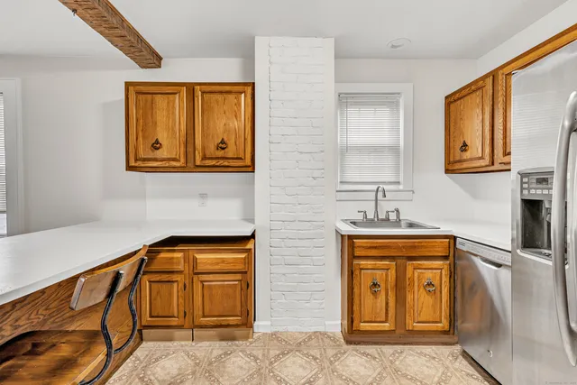a view of a door with a sink and cabinets