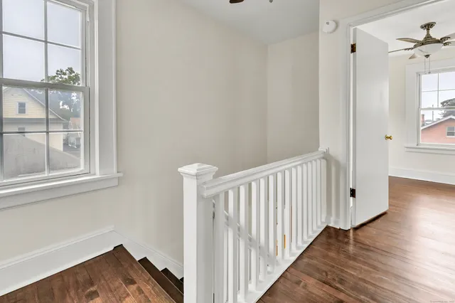 a view of a hallway with wooden floor and entryway