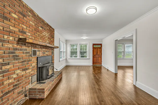 wooden floor in a hall with an empty room and wooden floor
