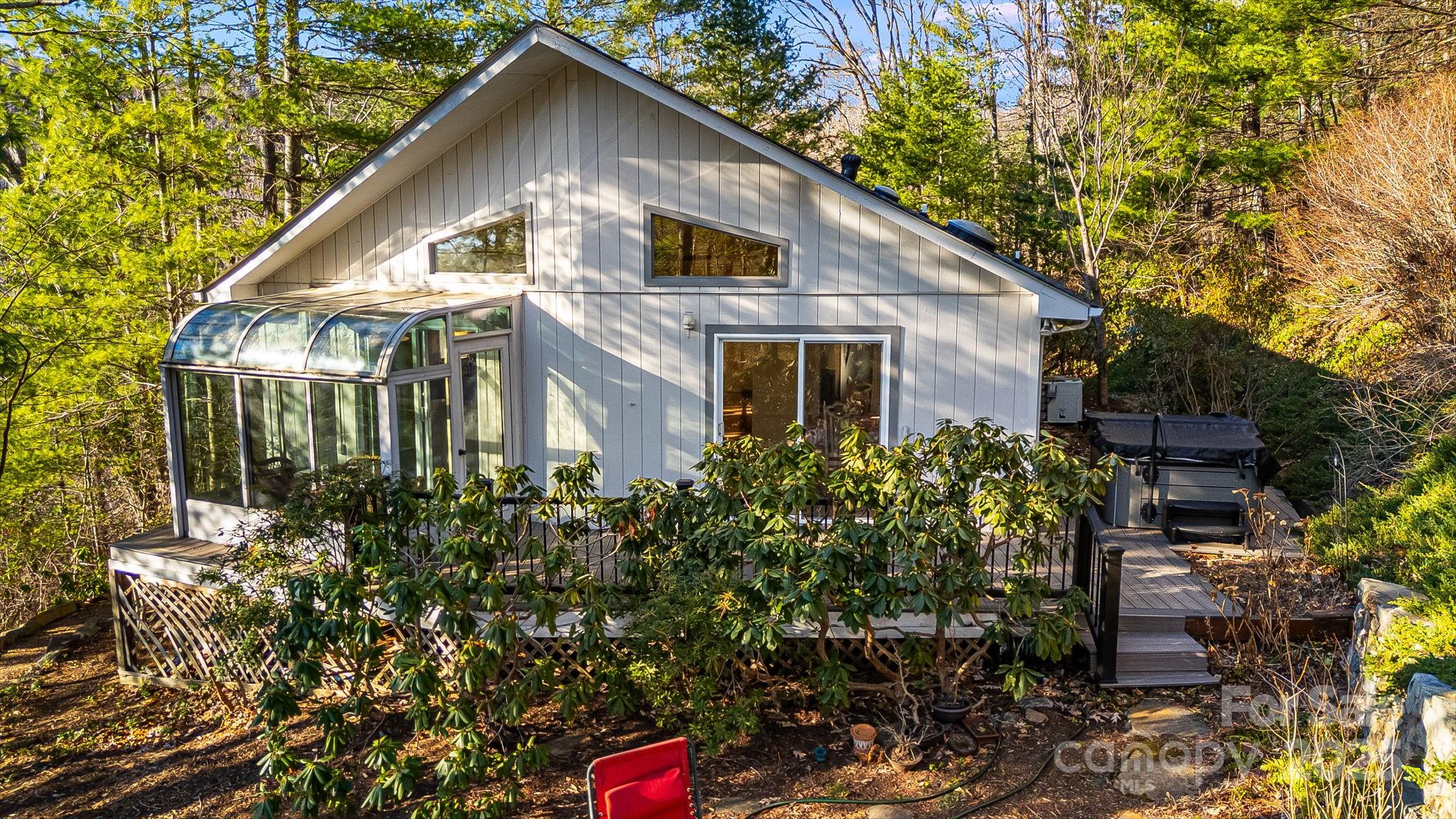 a front view of a house with plants