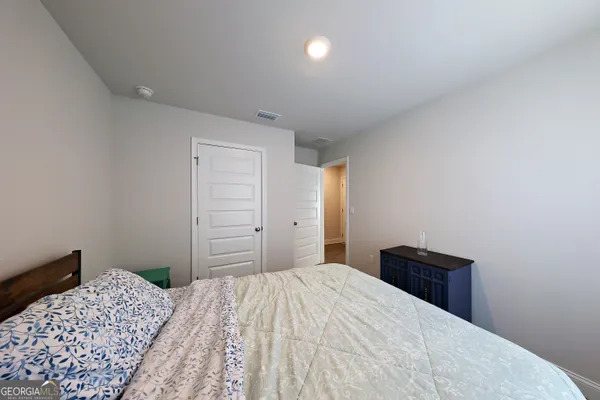 a bedroom with a bed and a closet