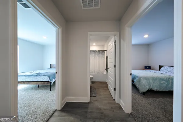 a bedroom with bed and hallway