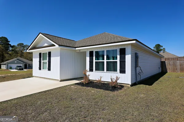a front view of a house with a yard