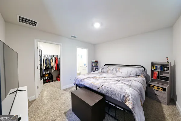 a bed sitting in a bedroom next to a window