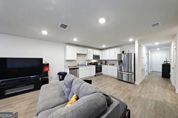a living room with furniture and a flat screen tv