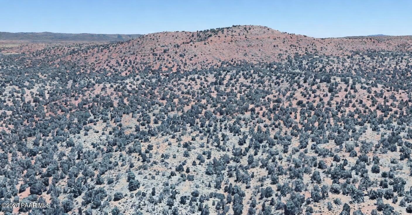 a large building with a mountain in the background