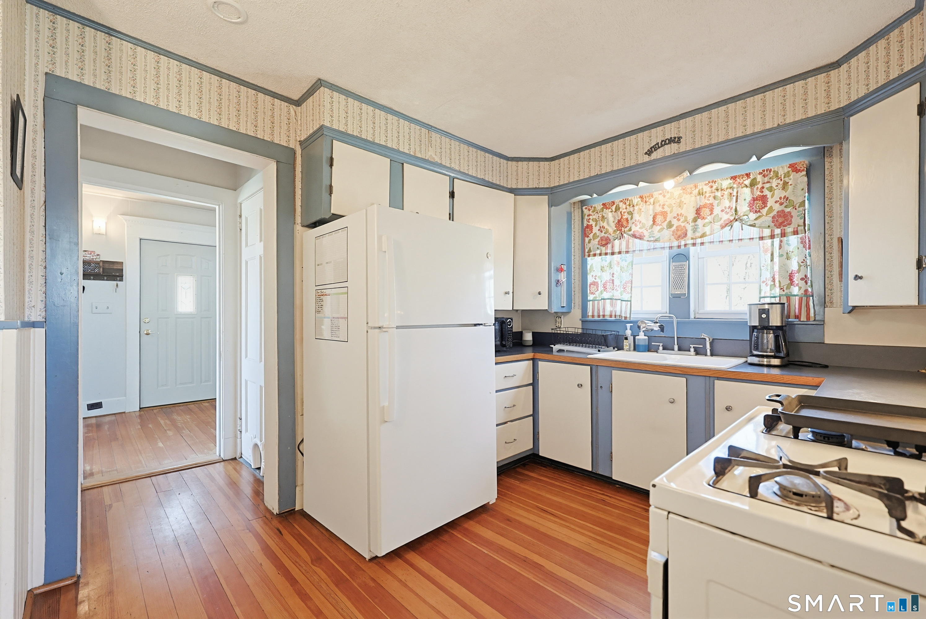 19 Church Street Plainfield, CT 06374 - Photo 14 of 39 a kitchen with a refrigerator a stove a sink and wooden floor