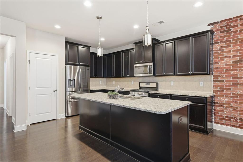 123 Longleaf Drive Canton, GA 30114 - Photo 15 of 39 a kitchen with stainless steel appliances granite countertop a sink stove and refrigerator