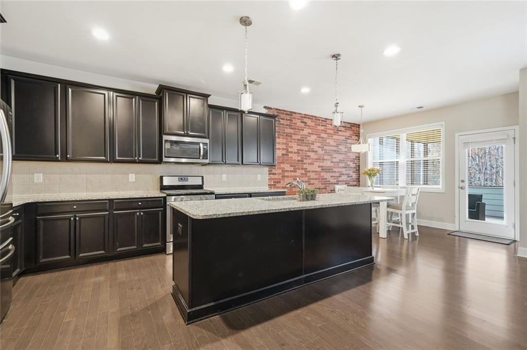123 Longleaf Drive Canton, GA 30114 - Photo 16 of 39 a kitchen with stainless steel appliances granite countertop a stove a sink and a microwave