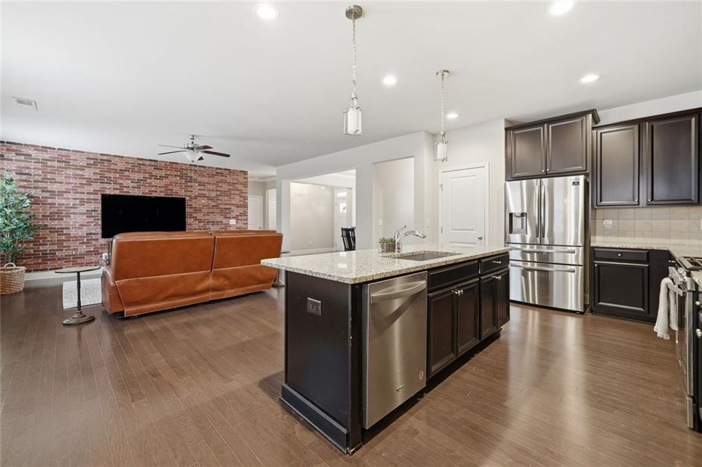 123 Longleaf Drive Canton, GA 30114 - Photo 18 of 39 a kitchen with stainless steel appliances kitchen island granite countertop a stove a sink and a refrigerator