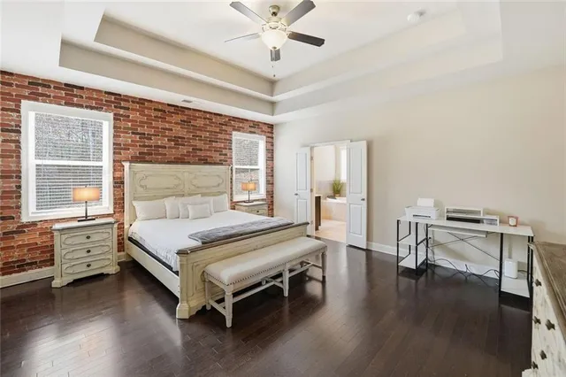 a bedroom with a bed and a table chair