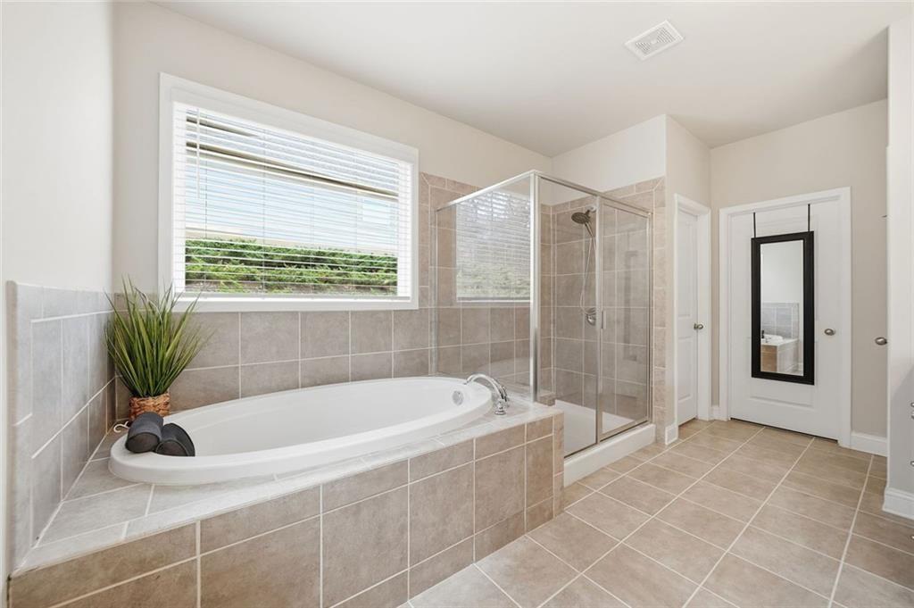 123 Longleaf Drive Canton, GA 30114 - Photo 20 of 39 a white bath tub sitting in a bathroom next to a window