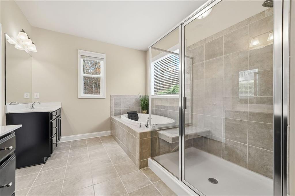 123 Longleaf Drive Canton, GA 30114 - Photo 22 of 39 a bathroom with a bathtub and a shower